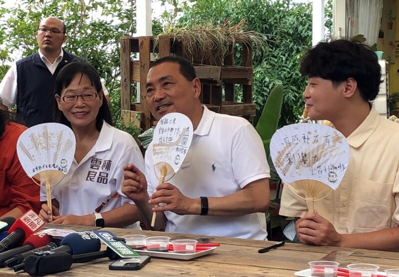 國民黨總統參選人侯友宜（前中）6日到雲林縣進行參訪行程，在副縣長謝淑亞（前左）陪同下，前往古坑鄉體驗手繪紙扇。中央社