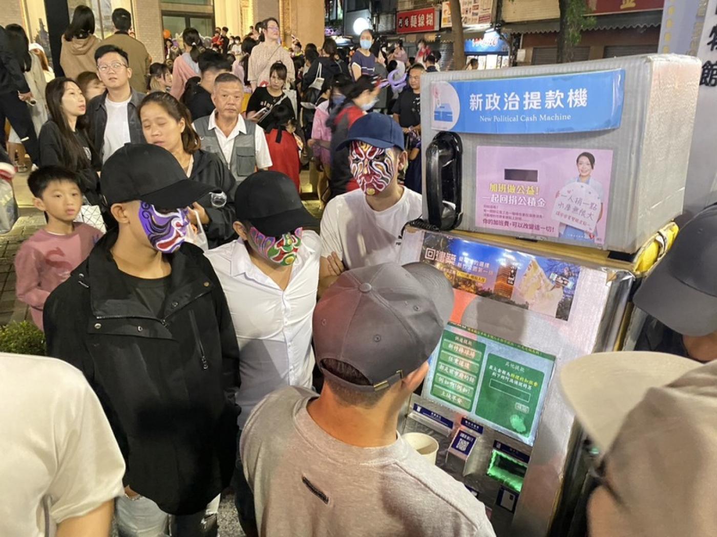 新竹市政府28日舉辦萬聖節遊行活動，數名畫著臉譜的男子包圍「新政治提款機」，並阻擋民眾靠近。中央社