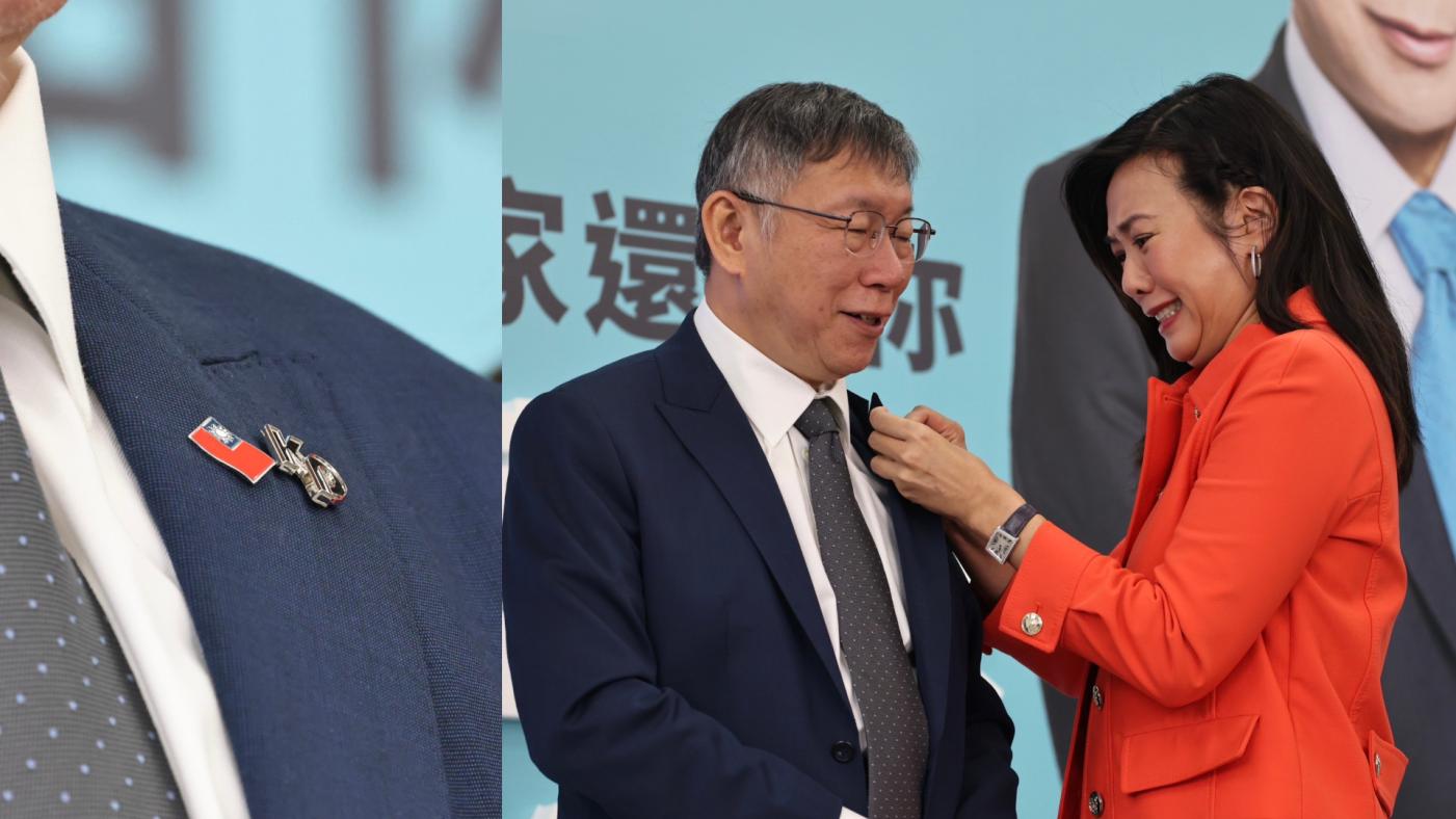 吳欣盈為柯文哲別上國旗徽章。林啟弘攝